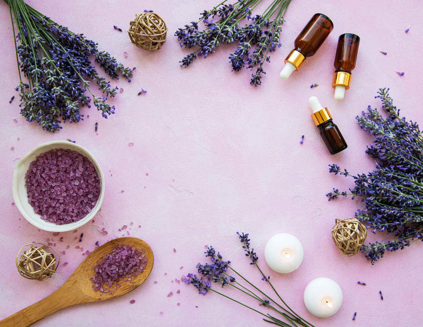 Lavender Flowers and Essential Oil Bottles on Purple Background